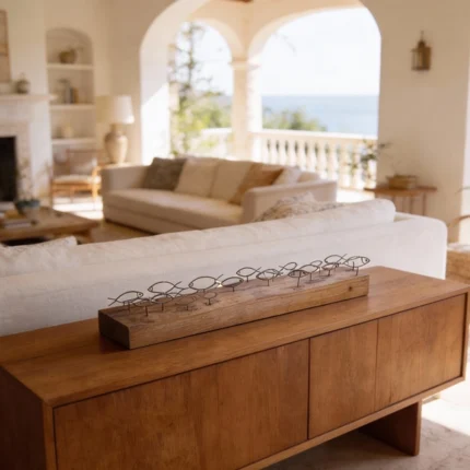 Fishes Swimming a dynamic metal sculpture of stylized fish swimming together, mounted on a natural wood base. The flowing composition captures movement and harmony, while the combination of rustic metal and warm wood adds texture and an organic touch. Ideal for: Coastal-inspired interiors, living rooms, offices, or spaces celebrating nature and natural materials.