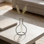 This decorative piece Round Outline Vase  features a metal outline in the shape of a vase, offering a minimalist silhouette with a sculptural feel. Perfect for showcasing a single stem in its glass tube, it adds a subtle, artistic touch to your space. (glass tube vase included)