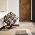 Introduce a harmonious blend of nature and geometry into your space with the Tree Branch Cube, a captivating creation by architect and designer Dimitris Zelios. This minimalist metal sculpture encapsulates the organic beauty of tree branches within the structured form of a cube, offering a contemporary piece that evokes both strength and serenity. Its versatile structure makes it a perfect addition to any space seeking artistic sophistication and a touch of nature-inspired tranquility.