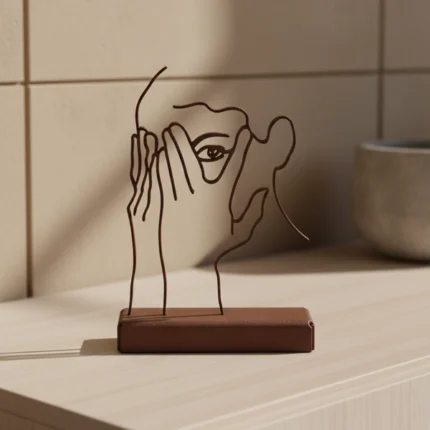 Hidden Grace a minimalist metal sculpture featuring an abstract human face profile, elegantly crafted with clean lines and subtle contours. The design evokes a sense of inner strength and quiet elegance, making it a timeless addition to any space. Ideal for: Modern living rooms, bedrooms, offices, or any area seeking a touch of understated sophistication.