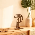 Geometric Toucan. A minimalist metal toucan with a clean, graphic silhouette. Its elegant lines and playful form add a refined tropical accent to shelves, consoles, or desks, making it a subtle statement piece for modern and curated interiors.