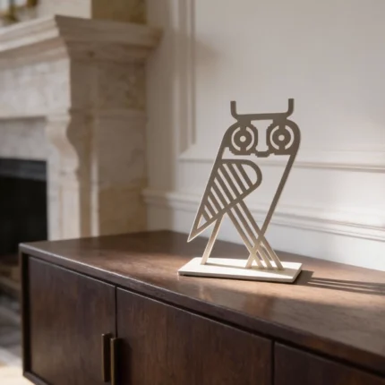 Owl Decorative Object. A refined metal owl sculpture with a minimalist, architectural form. Compact yet expressive, it stands as a subtle statement piece on shelves, consoles, or desks, bringing character and quiet elegance to any interior. Ideal for contemporary, modern, or curated spaces.