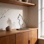 A minimalist metal sculpture capturing the sleek form and curious posture of a cat. Its simple lines create a calm yet playful presence with a durable design ideal for both indoor and outdoor settings. Ideal for: Shelves, desks, cozy corners, gardens, or outdoor spaces in homes or offices with a love for feline grace. 