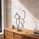 A minimalist metal sculpture capturing the sleek form and curious posture of a cat. Its simple lines create a calm yet playful presence with a durable design ideal for both indoor and outdoor settings. Ideal for: Shelves, desks, cozy corners, gardens, or outdoor spaces in homes or offices with a love for feline grace.