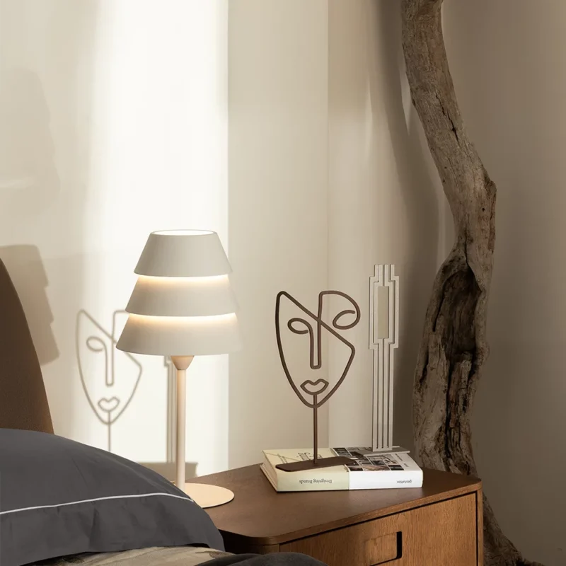 Face a minimalist metal sculpture featuring an abstract human face profile. Crafted with clean lines and smooth contours, this piece captures the essence of human expression in a contemporary form. Its subtle design adds a touch of sophistication to any space. Ideal for: Modern living rooms, offices, or spaces seeking a unique and artistic accent.